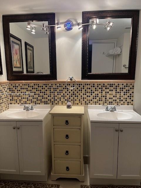 bathroom featuring decorative backsplash and vanity