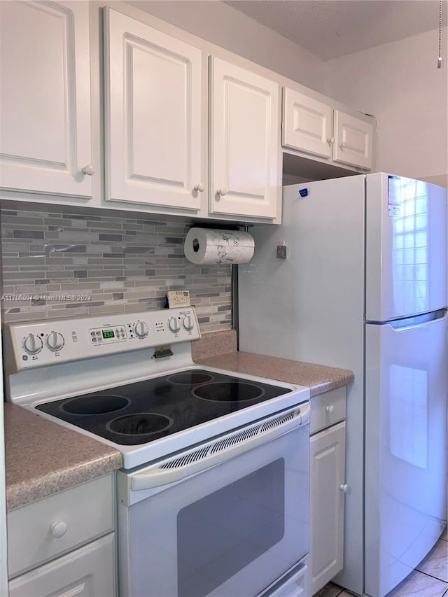 kitchen with white range with electric cooktop, white cabinetry, and decorative backsplash