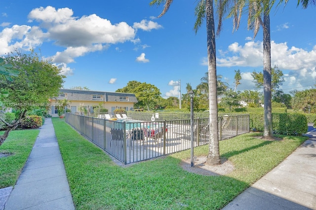 view of pool with a lawn