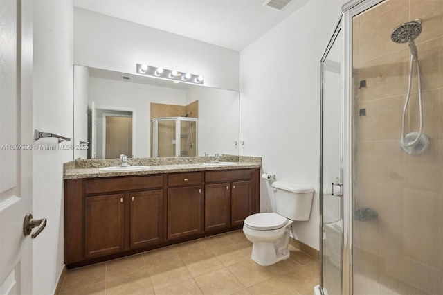 full bathroom with toilet, a shower stall, double vanity, and a sink