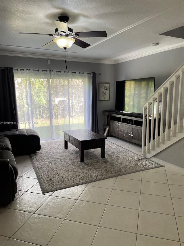 tiled living room with crown molding, ceiling fan, and a textured ceiling