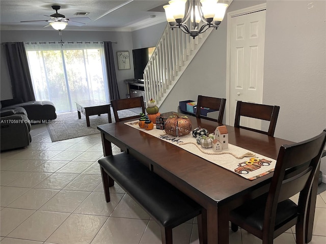 dining area with ceiling fan with notable chandelier, ornamental molding, and light tile patterned flooring