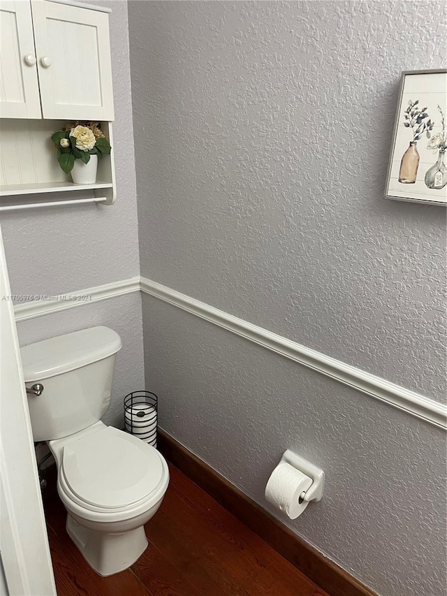 bathroom featuring hardwood / wood-style floors and toilet