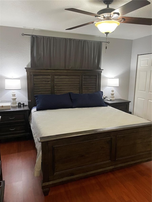 bedroom featuring ceiling fan and dark hardwood / wood-style flooring