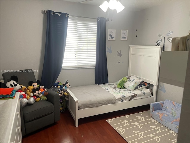 bedroom featuring ceiling fan and dark wood-type flooring