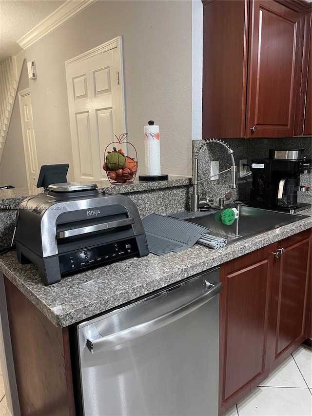 kitchen with decorative backsplash, crown molding, light tile patterned floors, and stainless steel dishwasher