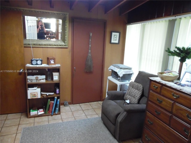 sitting room featuring vaulted ceiling with beams and light tile patterned floors