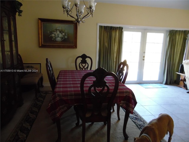 dining room with french doors, light tile patterned floors, and a notable chandelier