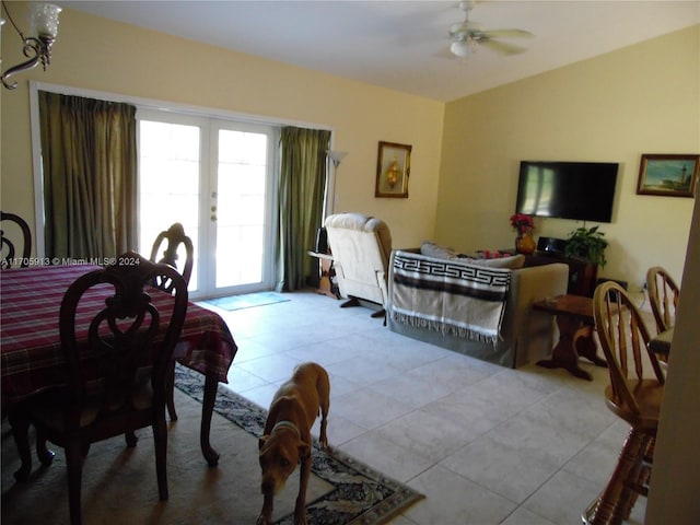 dining space featuring french doors, ceiling fan, and light tile patterned flooring