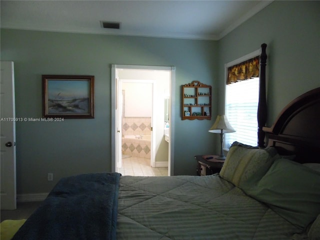 bedroom featuring ensuite bathroom and ornamental molding