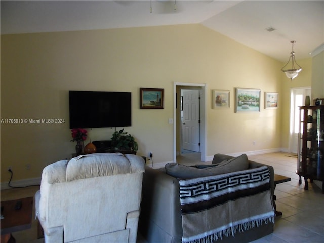 living room with light tile patterned floors and vaulted ceiling