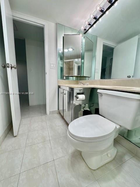 bathroom featuring vanity, toilet, and tile patterned flooring