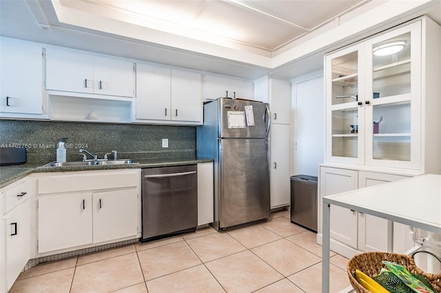 kitchen featuring decorative backsplash, white cabinetry, sink, and stainless steel appliances