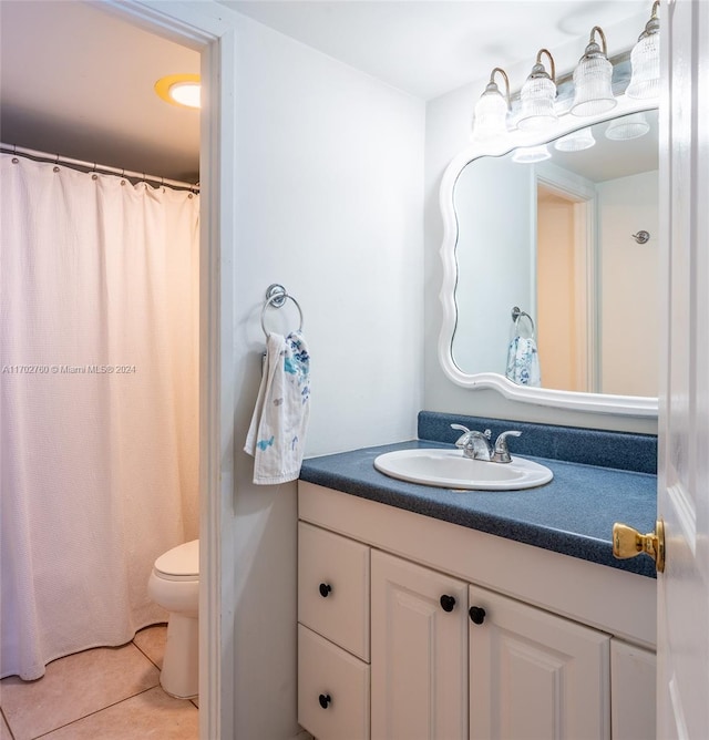 bathroom featuring tile patterned flooring, vanity, and toilet