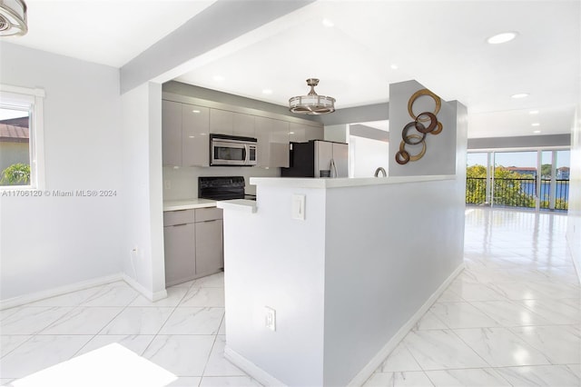 kitchen featuring plenty of natural light, gray cabinets, and appliances with stainless steel finishes