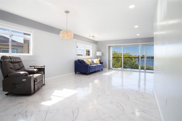 1400 SW 131st Way Unit 401Q, Pembroke Pines, FL 33027 - living area with marble look tiles, recessed lighting, and a chandelier