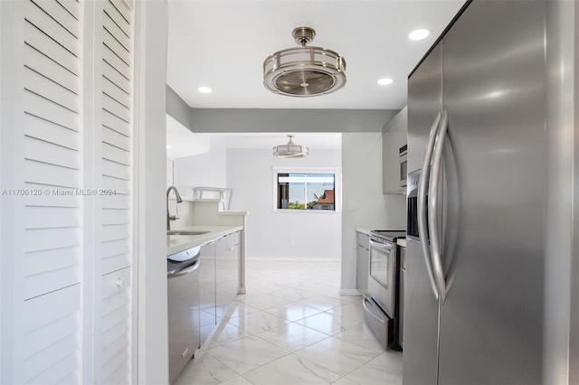 1400 SW 131st Way Unit 401Q, Pembroke Pines, FL 33027 - kitchen featuring appliances with stainless steel finishes, light marble finish floors, light countertops, recessed lighting, and decorative light fixtures