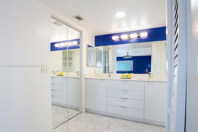 1400 SW 131st Way Unit 401Q, Pembroke Pines, FL 33027 - bathroom with marble look tiles, double vanity, and a chandelier