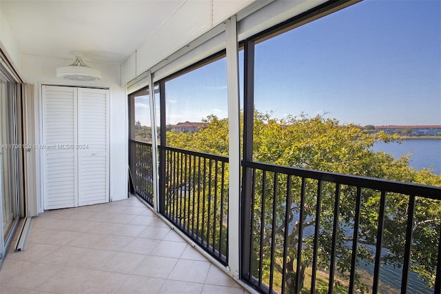 unfurnished sunroom featuring a water view