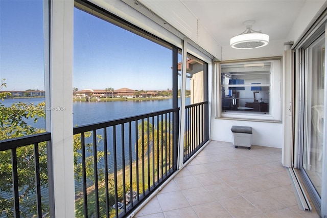 unfurnished sunroom with a water view