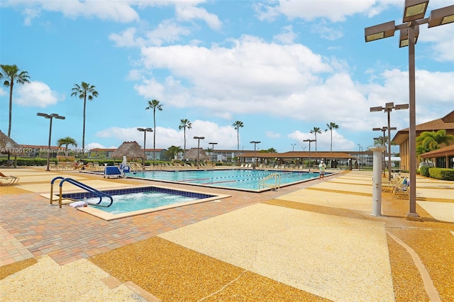 view of pool featuring a patio and a hot tub