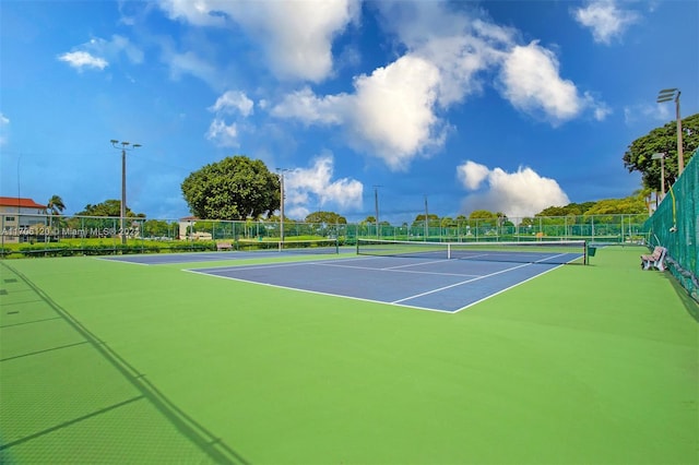 view of tennis court with basketball hoop