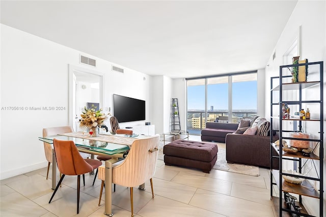 tiled living room featuring expansive windows