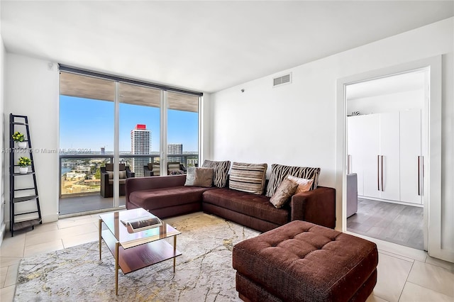 living room with floor to ceiling windows and light wood-type flooring