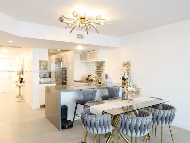 dining area featuring baseboards and visible vents