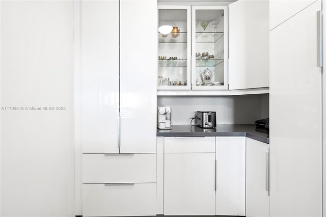 kitchen featuring white cabinets, light tile patterned floors, backsplash, and stainless steel appliances