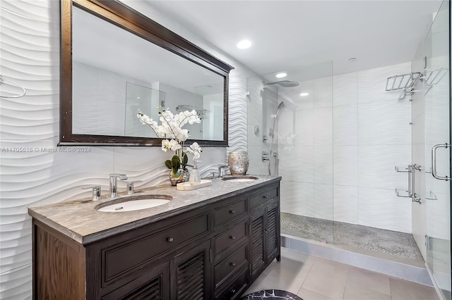 bathroom featuring tile patterned floors, vanity, and tiled shower