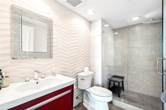 bathroom with vanity, a shower with shower door, and toilet