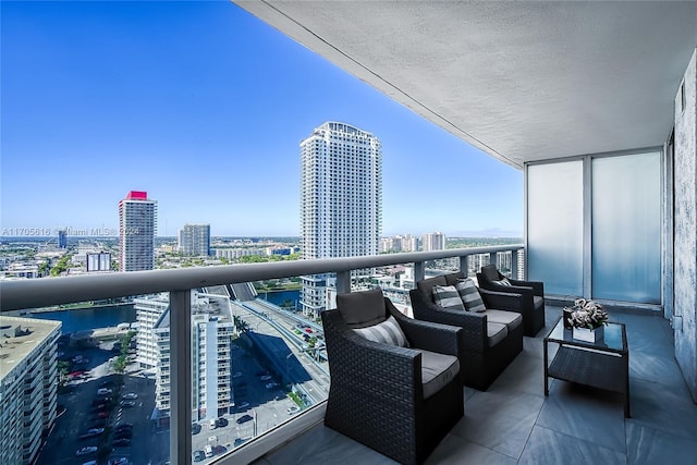 balcony featuring an outdoor living space and a water view