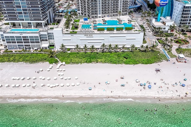 drone / aerial view with a water view and a beach view