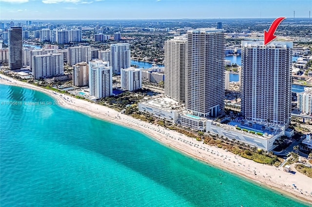 birds eye view of property featuring a view of the beach and a water view