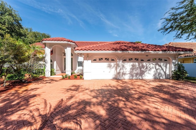 mediterranean / spanish home with a garage