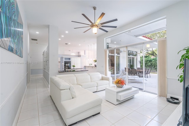 living room with light tile patterned floors, baseboards, a ceiling fan, and recessed lighting