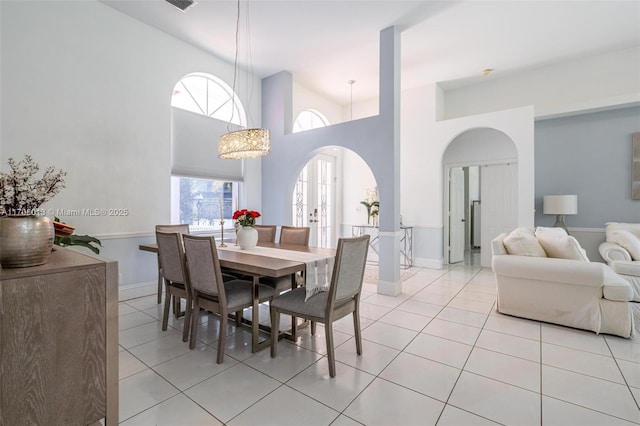 tiled dining area featuring french doors