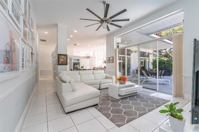 living room with ceiling fan and light tile patterned flooring