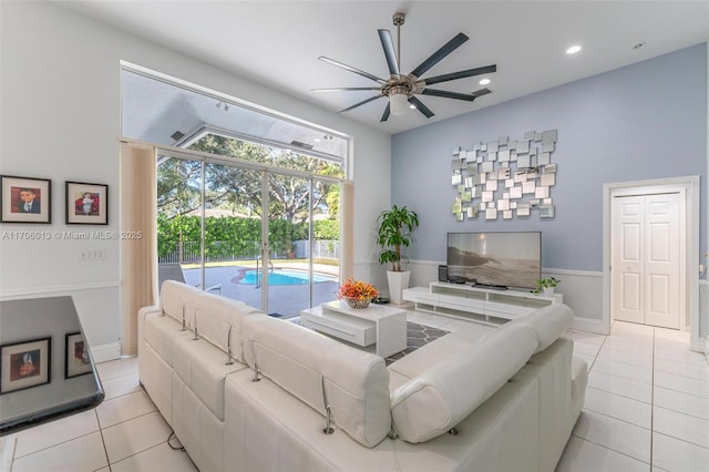 living room with light tile patterned floors and ceiling fan