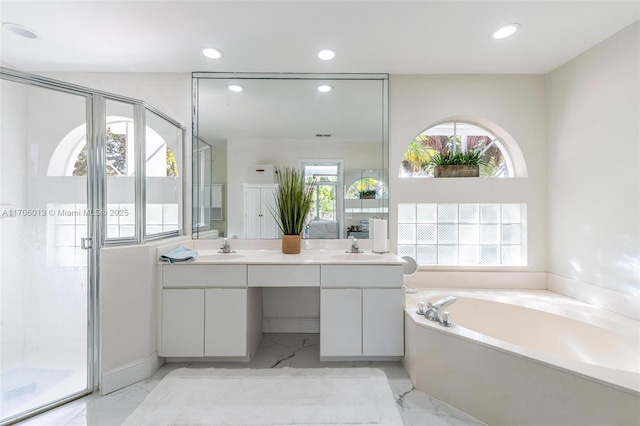 bathroom with vanity and separate shower and tub