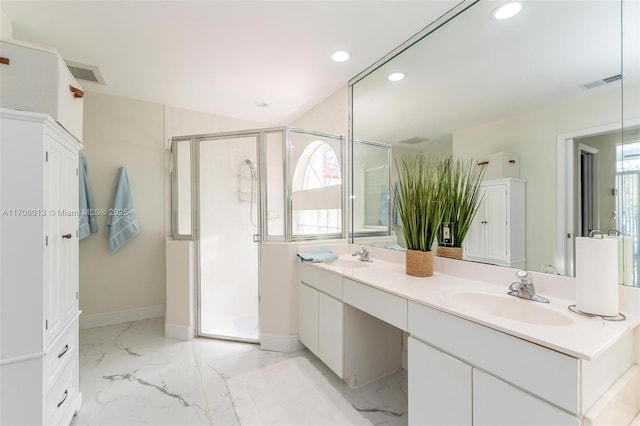 bathroom with a shower with shower door, a wealth of natural light, and vanity