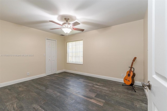 spare room with dark hardwood / wood-style floors and ceiling fan