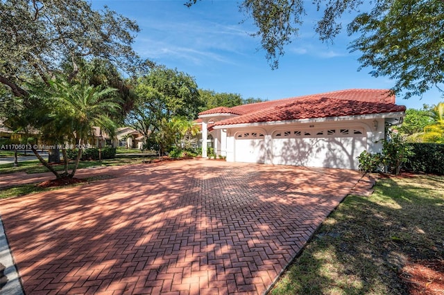 mediterranean / spanish-style home with a garage