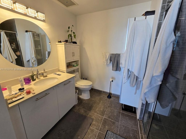 bathroom with tile patterned floors, vanity, and toilet