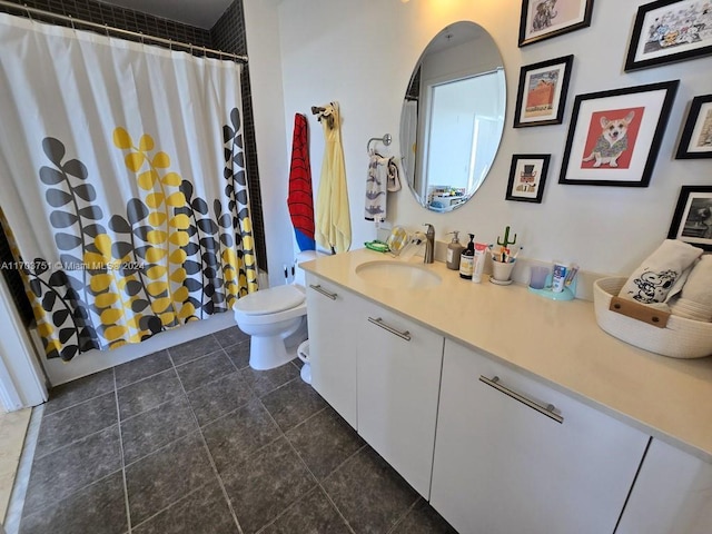 bathroom with tile patterned floors, curtained shower, vanity, and toilet