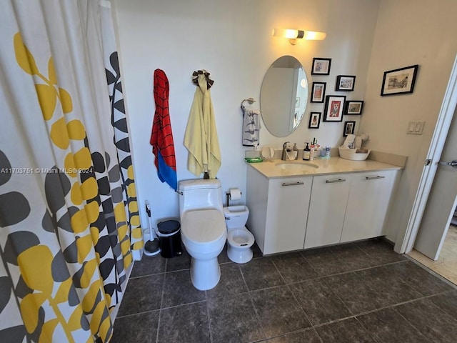 bathroom featuring tile patterned flooring, vanity, and toilet