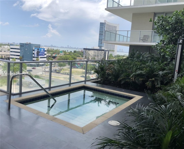 view of swimming pool featuring a hot tub