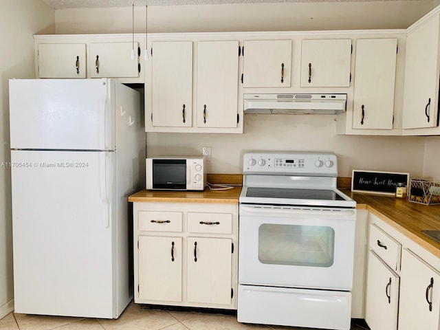 kitchen with white cabinets, light tile patterned floors, and white appliances