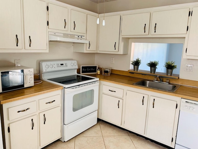 kitchen featuring white cabinetry, white appliances, sink, and light tile patterned floors